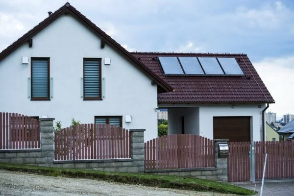 Dům s fotovoltaickými panely na střeše pro úsporu energie.