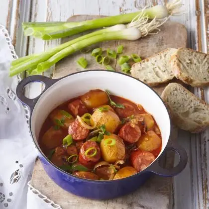 Hot French-style potatoes with sausages in rich tomato sauce.